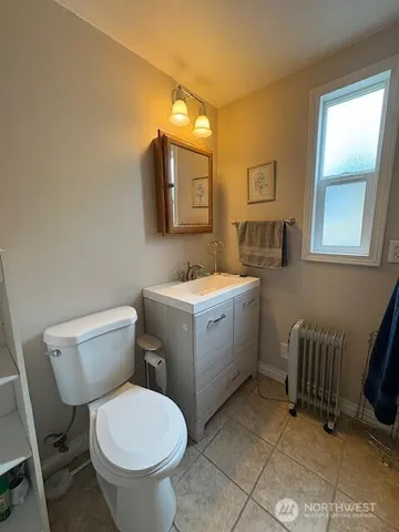 a bathroom with a toilet sink and mirror