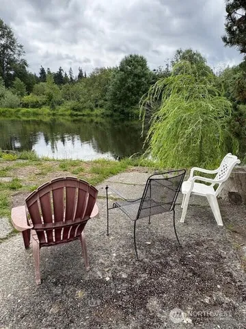 a view of a chairs and table on the lake