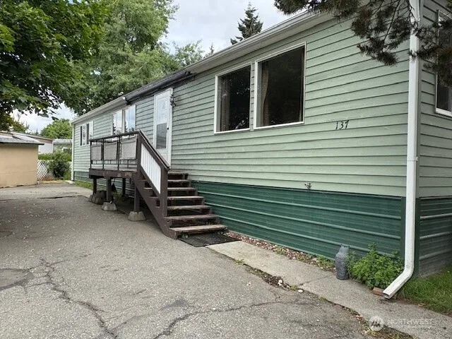 a back view of a house with a yard