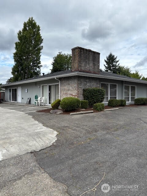 7301 Northeast 175th Street, Unit 137 Kenmore, WA 98028 - Photo 23 of 24 a front view of a house with a yard