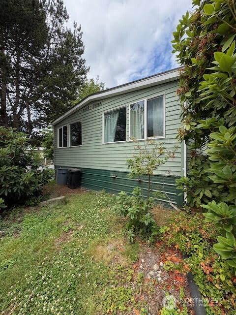 7301 Northeast 175th Street, Unit 137 Kenmore, WA 98028 - Photo 4 of 24 a backyard of a house with plants and tree