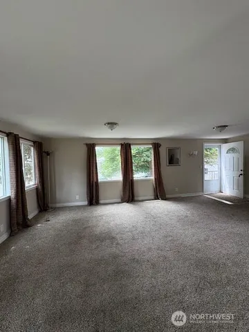 a view of a big room with windows and brick walls