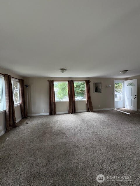 7301 Northeast 175th Street, Unit 137 Kenmore, WA 98028 - Photo 5 of 24 a view of a big room with windows and brick walls