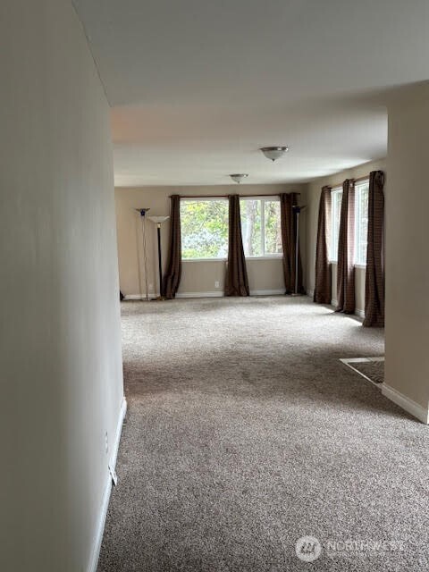 7301 Northeast 175th Street, Unit 137 Kenmore, WA 98028 - Photo 6 of 24 a view of an empty room with window and a kitchen