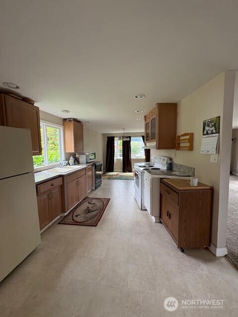 7301 Northeast 175th Street, Unit 137 Kenmore, WA 98028 - Photo 7 of 24 a kitchen with a refrigerator and a stove top oven