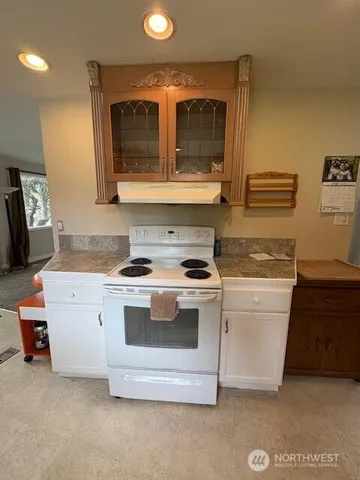 a kitchen with stainless steel appliances granite countertop a stove and a microwave