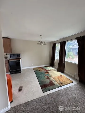 a view of kitchen with sink microwave and refrigerator