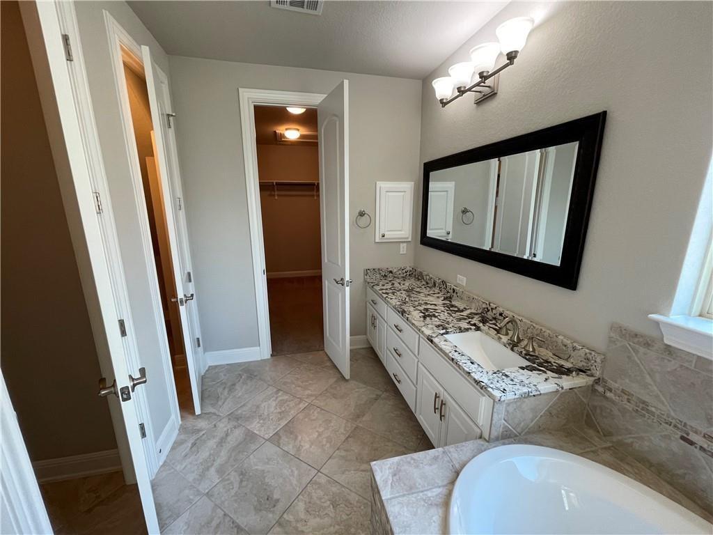 3501 Venezia View Leander, TX 78641 - Photo 12 of 20 a bathroom with a toilet sink and mirror
