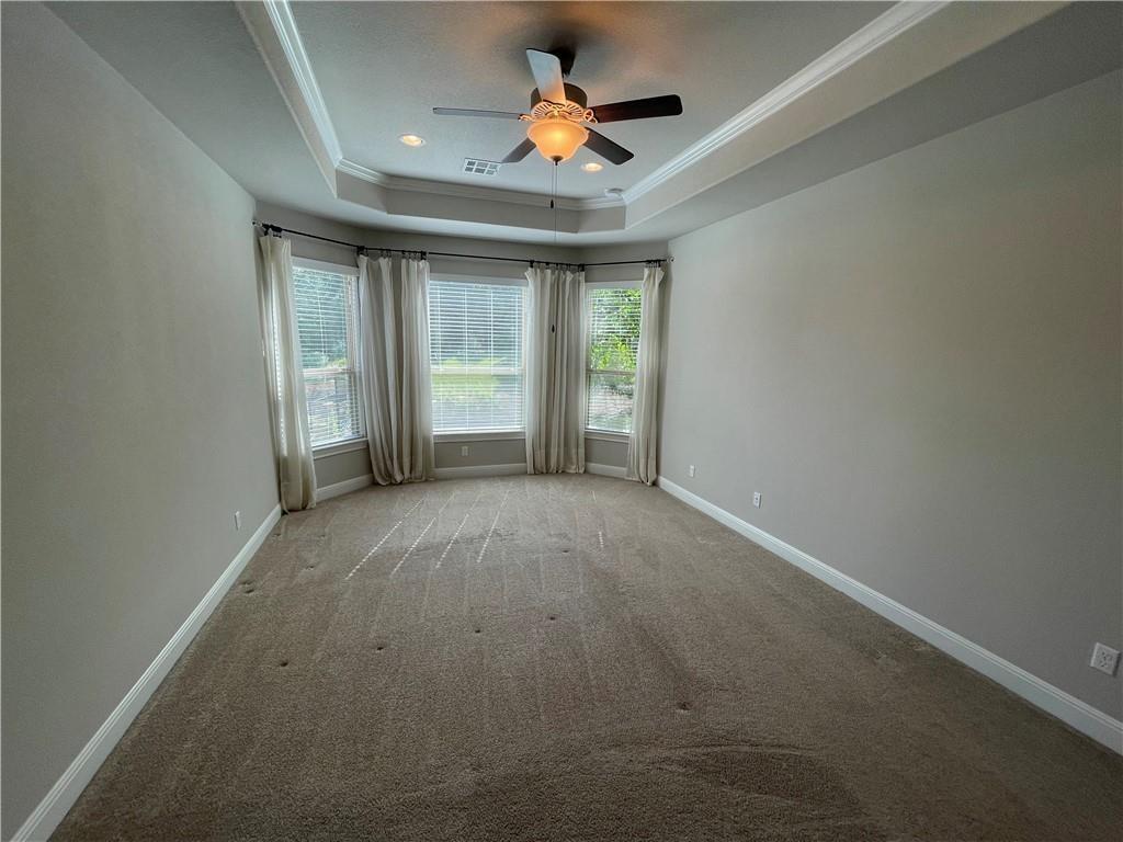 3501 Venezia View Leander, TX 78641 - Photo 13 of 20 en empty room with windows and chandelier fan