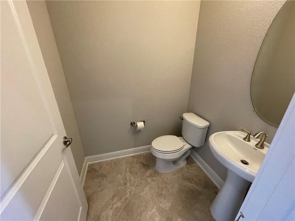 3501 Venezia View Leander, TX 78641 - Photo 16 of 20 a white toilet sitting next to a white sink and vanity
