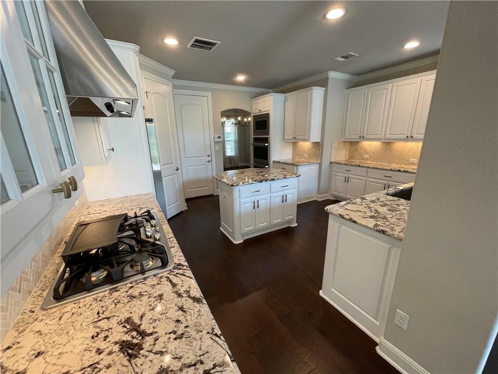 3501 Venezia View Leander, TX 78641 - Photo 3 of 20 a kitchen with a refrigerator a stove top oven a sink and white cabinets