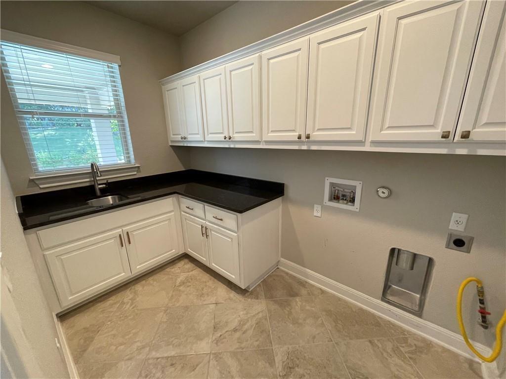 3501 Venezia View Leander, TX 78641 - Photo 7 of 20 a kitchen with granite countertop white cabinets and white appliances