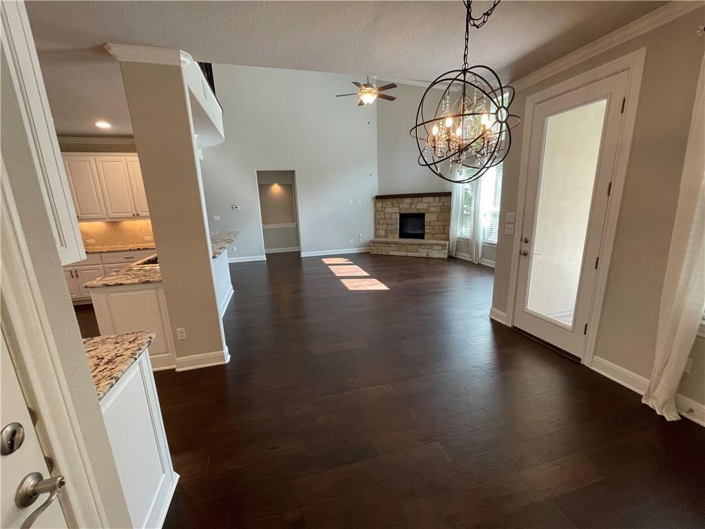3501 Venezia View Leander, TX 78641 - Photo 8 of 20 a view of a livingroom with wooden floor a flat screen tv and fireplace