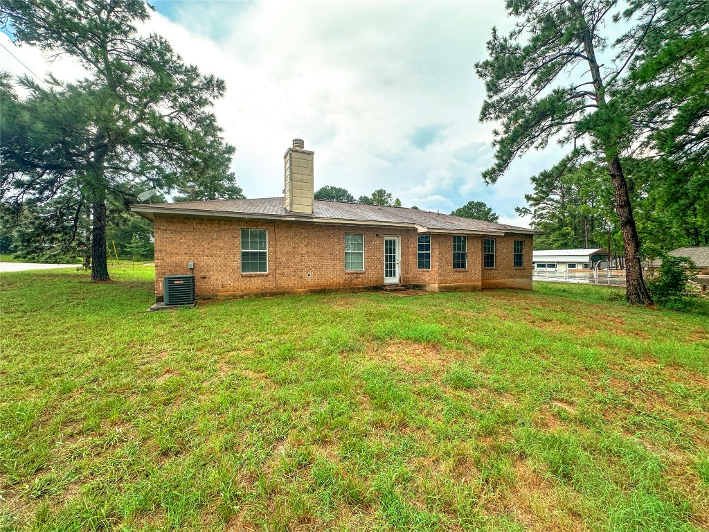 258 Pine View Loop Bastrop, TX 78602 - Photo 6 of 14 a front view of a house with a garden