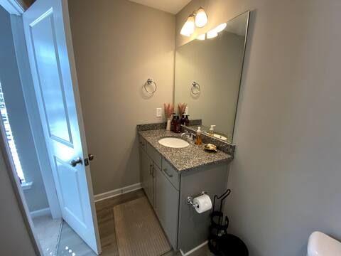 2788 Laurel Ridge Circle Atlanta, GA 30344 - Photo 9 of 16 a bathroom with a granite countertop sink a toilet and a mirror