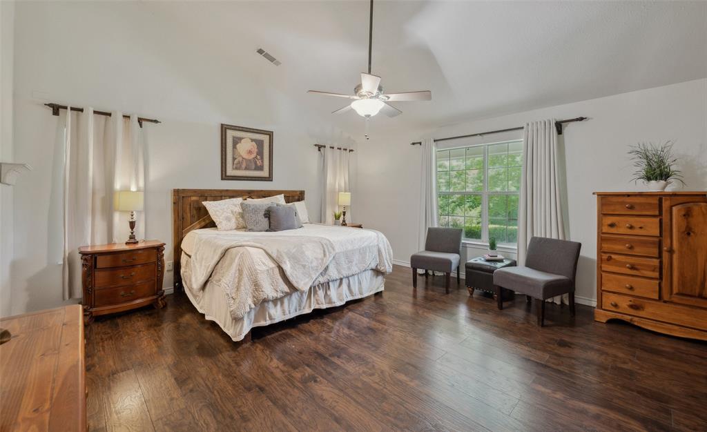 1000 Ballard Road Van Alstyne, TX 75495 - Photo 23 of 40 a bedroom with a bed and wooden floor