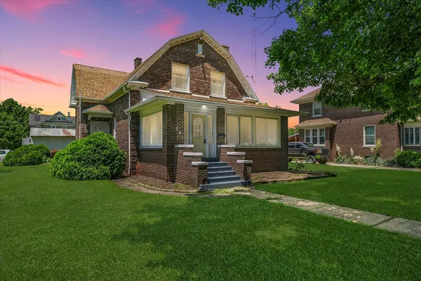 a front view of a house with a garden