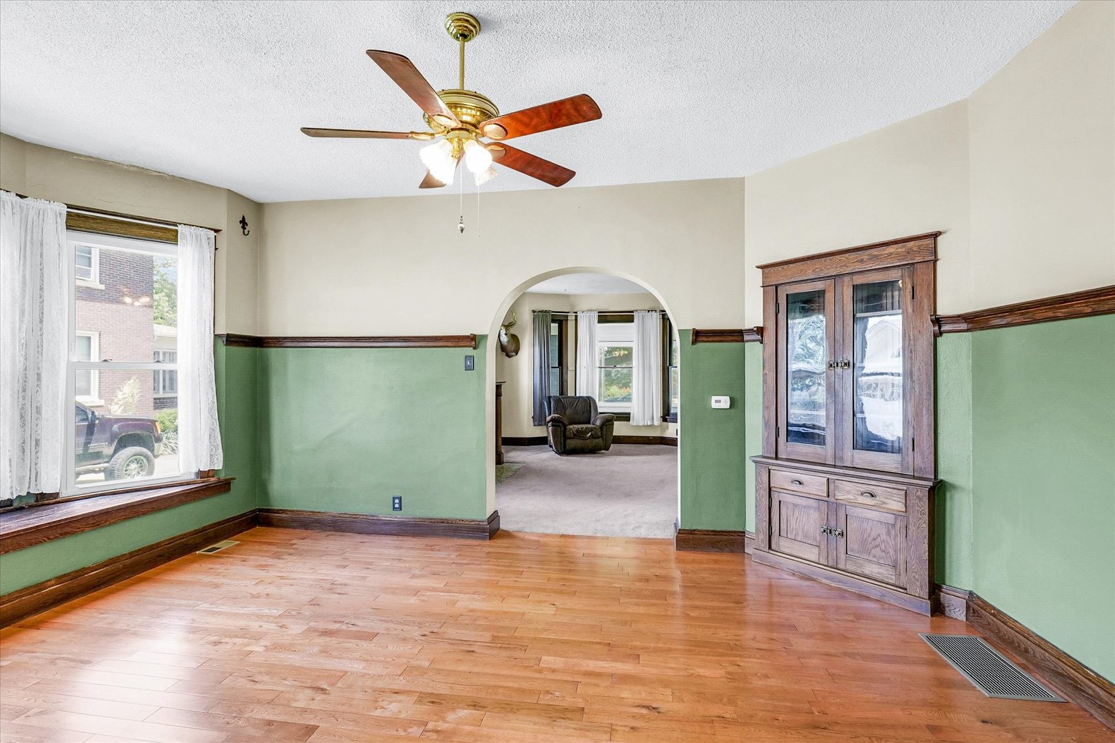 301 North Main Street Fithian, IL 61844 - Photo 14 of 53 a view of a livingroom with wooden floor a ceiling fan and a window