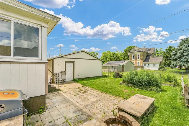 a view of a house with a yard and sitting area