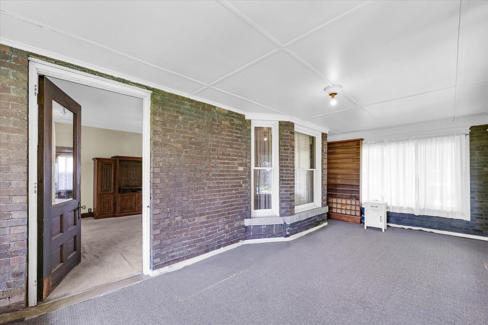 301 North Main Street Fithian, IL 61844 - Photo 6 of 53 a view of an empty room with a fireplace and a window