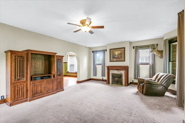 a living room with furniture flat screen tv and fireplace