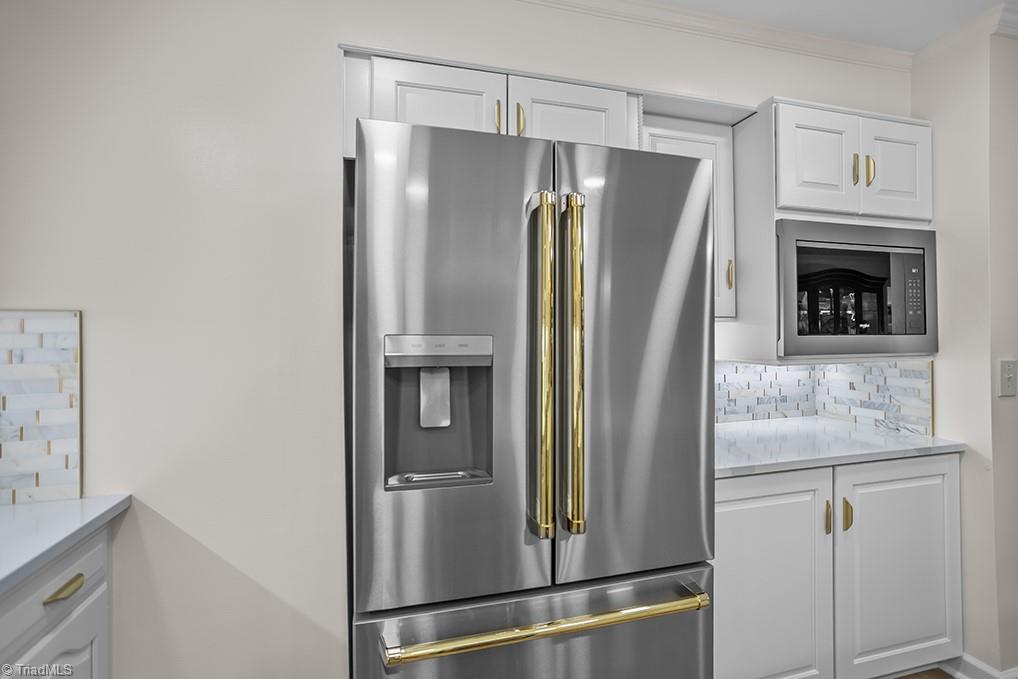120 Buckhaven Court Rural Hall, NC 27045 - Photo 16 of 47 The matching refrigerator to the gas range/oven and new cabinets that house the built-in microwave