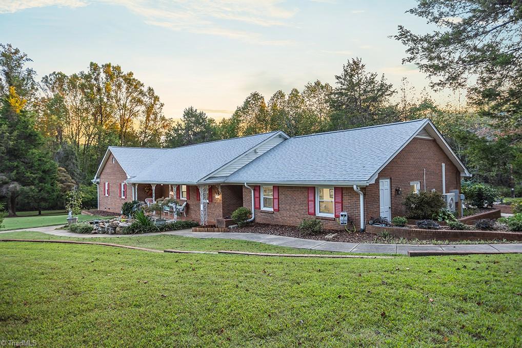 120 Buckhaven Court Rural Hall, NC 27045 - Photo 2 of 47 The concrete sidewalk wraps along the koi pond and around to the side and rear of the home.