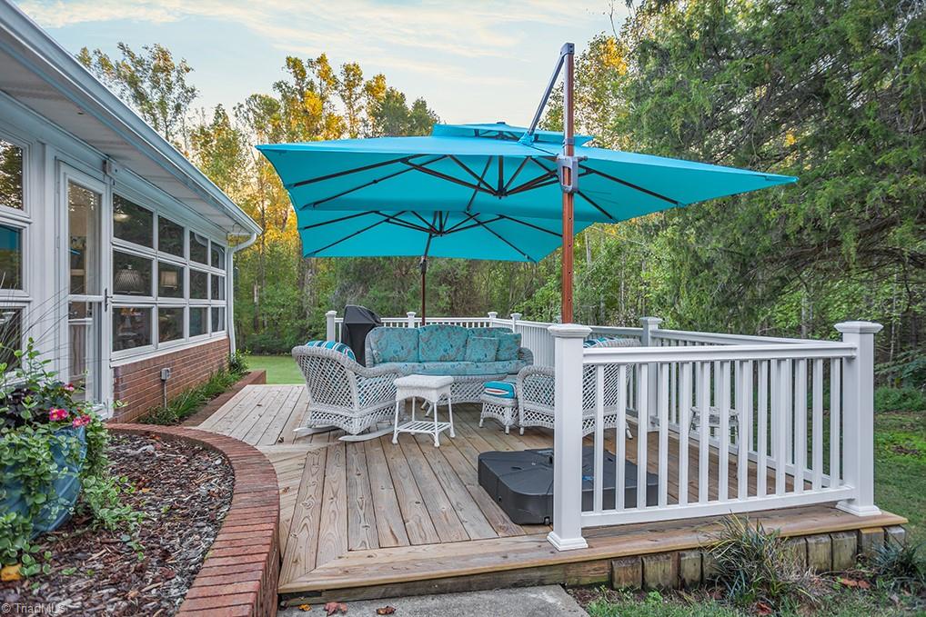 120 Buckhaven Court Rural Hall, NC 27045 - Photo 25 of 47 Just off the sunroom is a another door that leads to the newly constructed deck complete with white vinyl railing for ease of maintenance.
