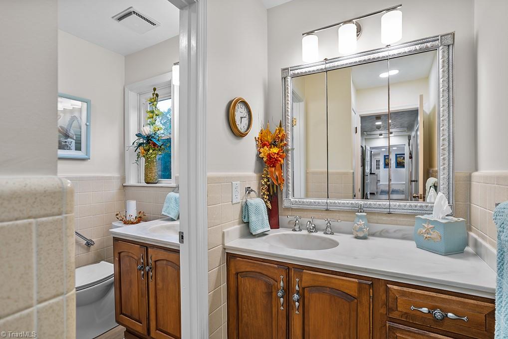 120 Buckhaven Court Rural Hall, NC 27045 - Photo 37 of 47 Bathroom 3 of 3 is located at the very end of the hallway. It offers dual but separate vanities, allowing 2 people to get ready at once.
