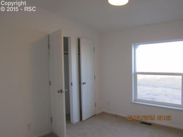 21376 County Road South, Unit 2 Rush, CO 80833 - Photo 5 of 17 Bedroom with closet space and a large window.