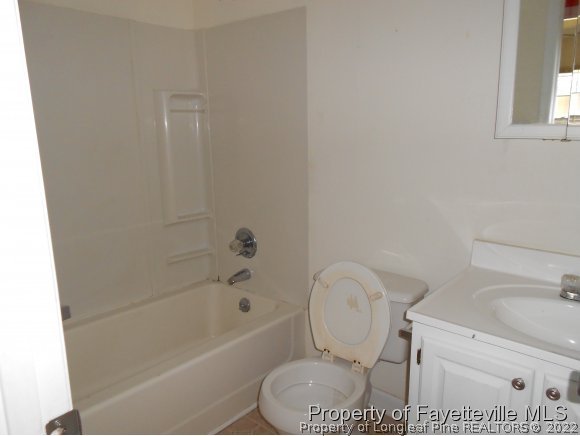 5862 Columbine Road Fayetteville, NC 28306 - Photo 10 of 10 a white toilet sitting next to a bath tub