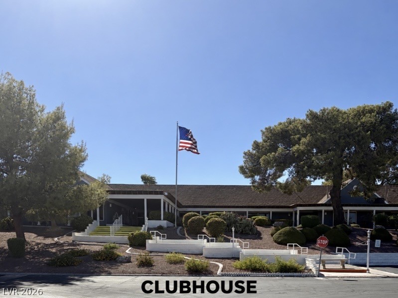 4556 Royal Ridge Way Las Vegas, NV 89103 - Photo 26 of 49 Mature trees frame the sprawling clubhouse architecture under a clear blue sky.