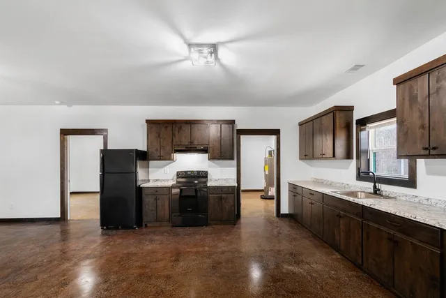 a large kitchen with cabinets and stainless steel appliances