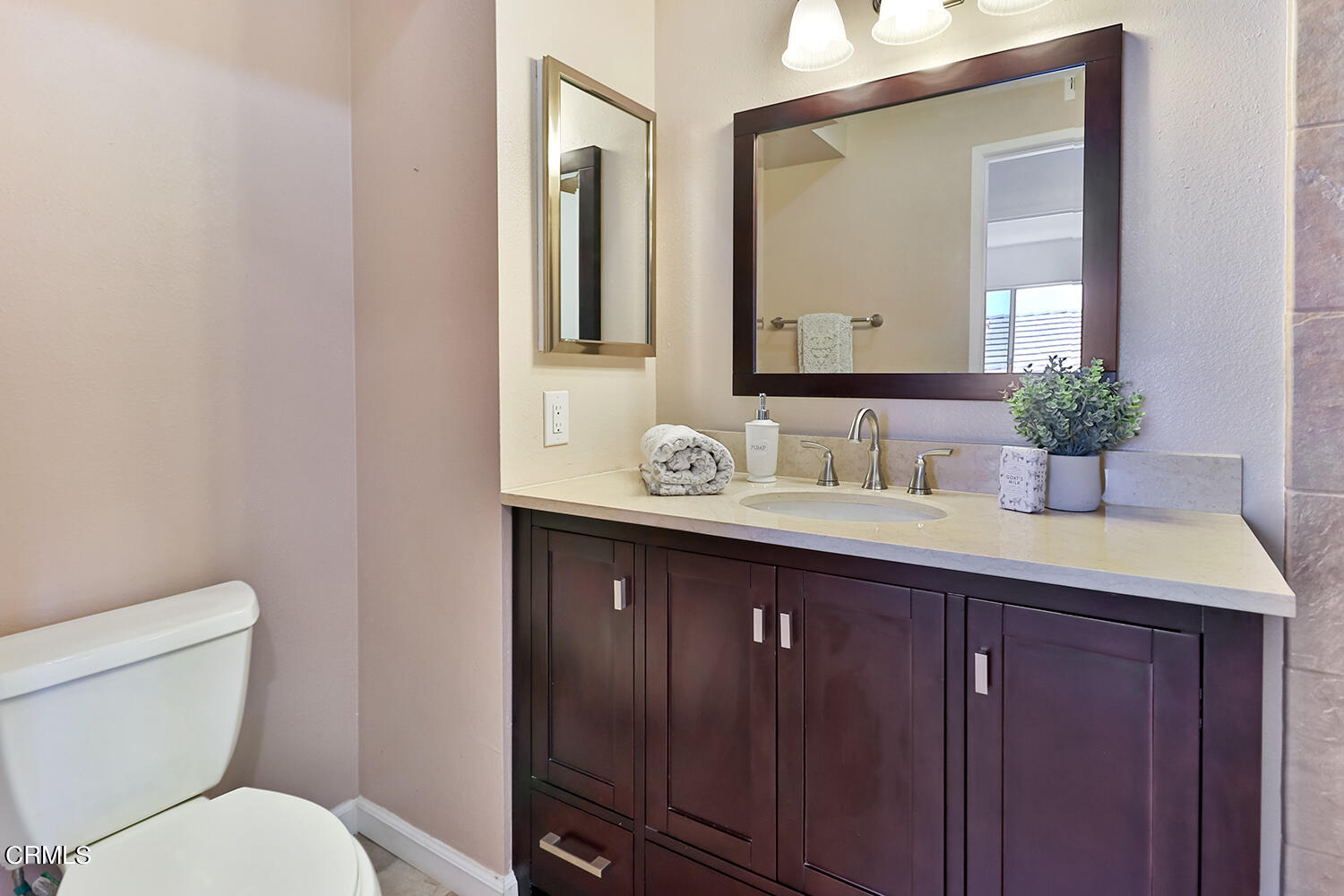 6159 Fremont Circle Camarillo, CA 93012 - Photo 33 of 48 a bathroom with a granite countertop toilet sink and mirror