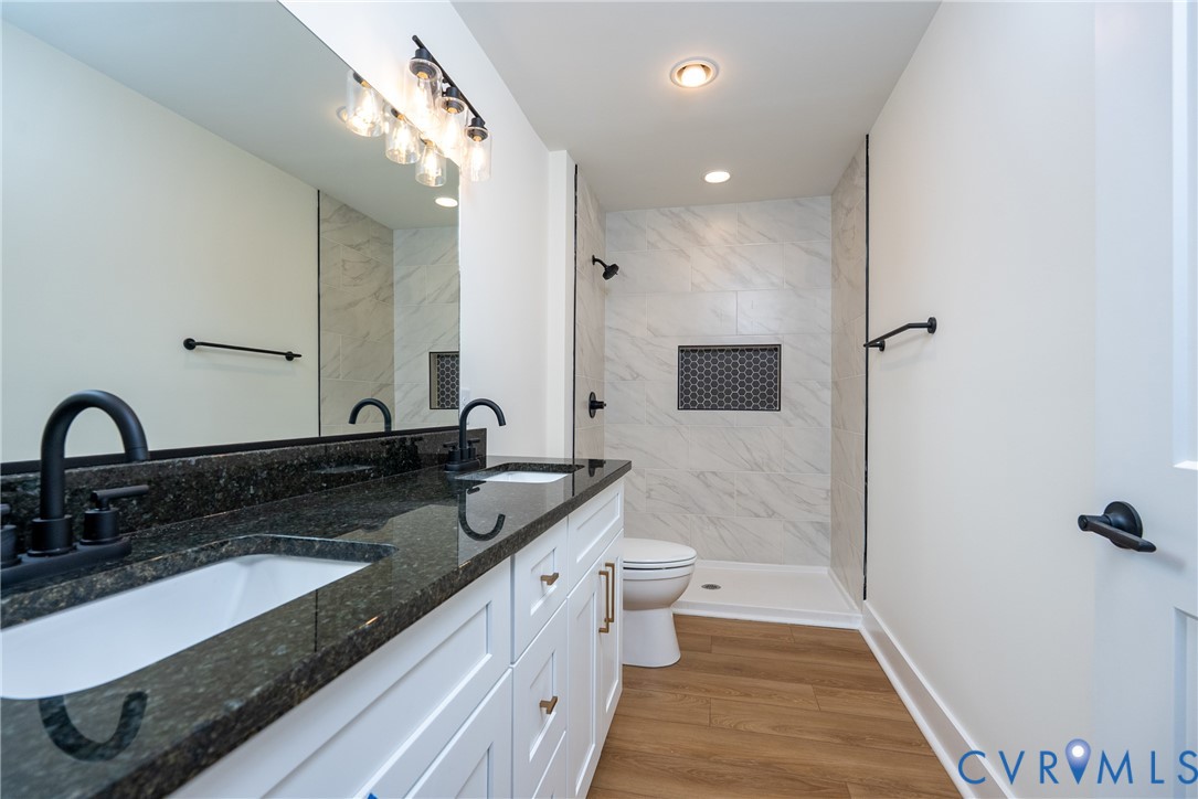 238 Ash Road Louisa, VA 23093 - Photo 20 of 43 a bathroom with a granite countertop double vanity sink a mirror and shower