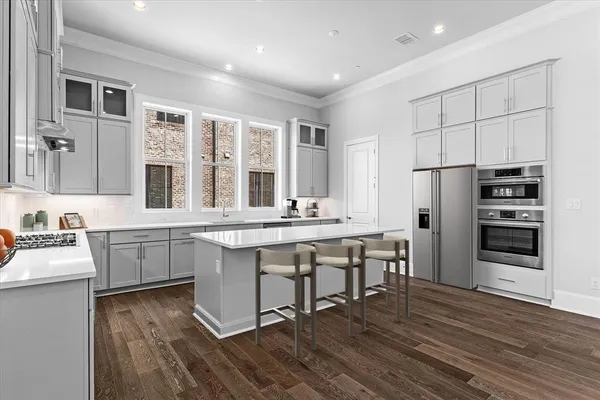 a kitchen with center island cabinets and refrigerator