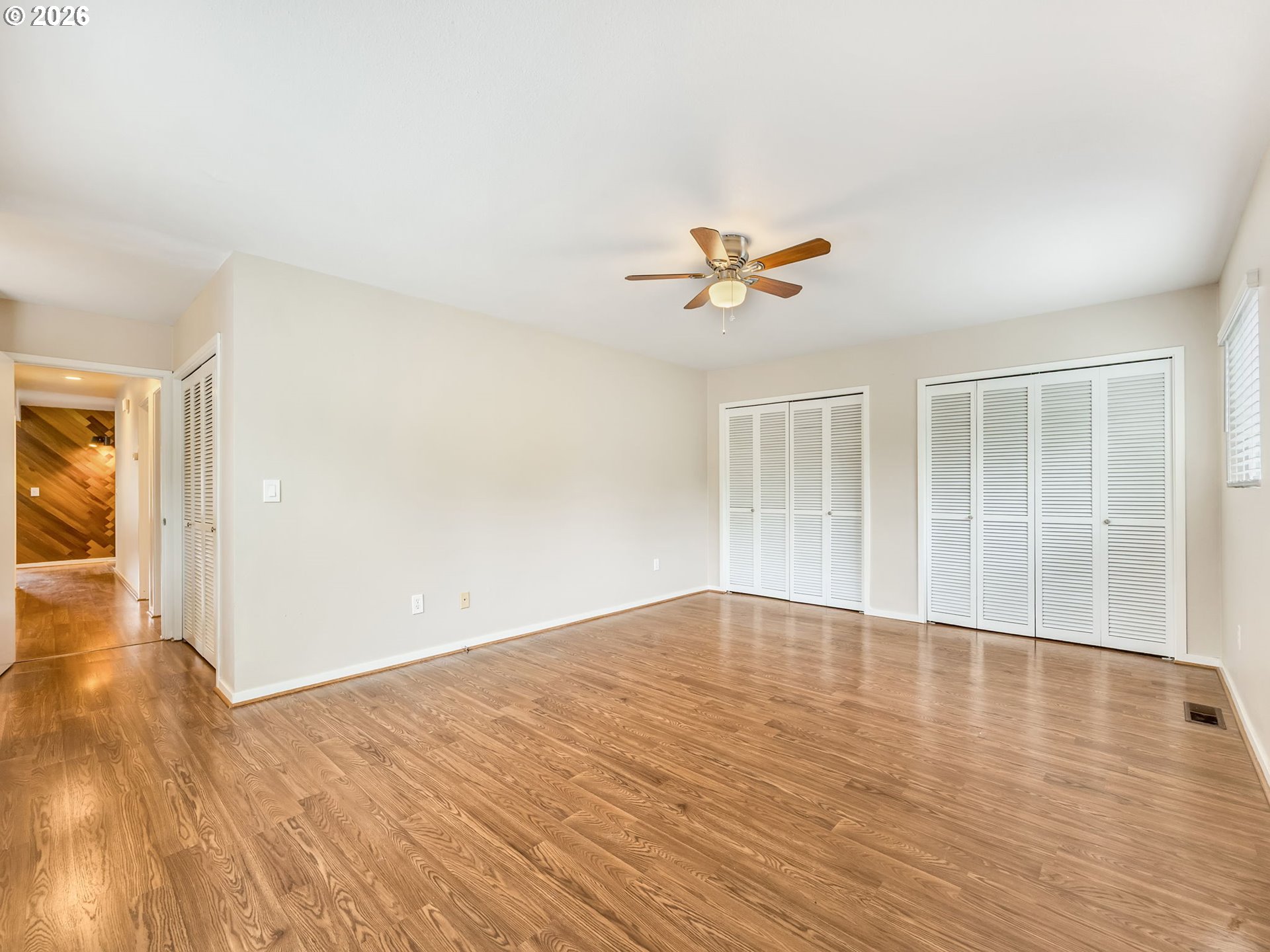91923 Ridge Road Warrenton, OR 97146 - Photo 21 of 35 an empty room with wooden floor and windows