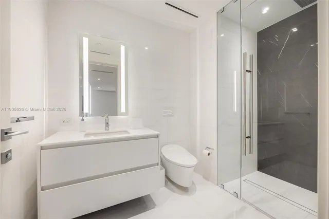a bathroom with a sink toilet and mirror