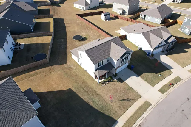 an aerial view of a house with a yard