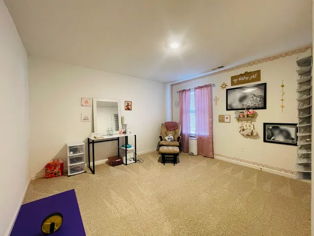 a bedroom with furniture and a flat screen tv