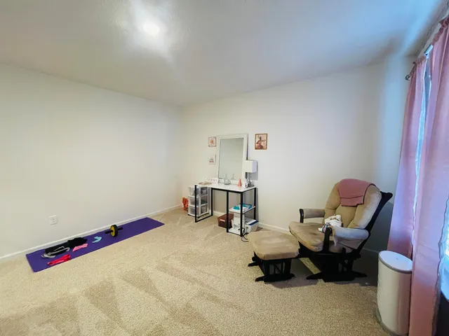 a view of a livingroom with furniture and a flat screen tv