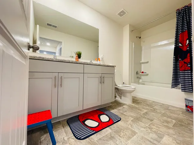 a living room with furniture and a book shelf