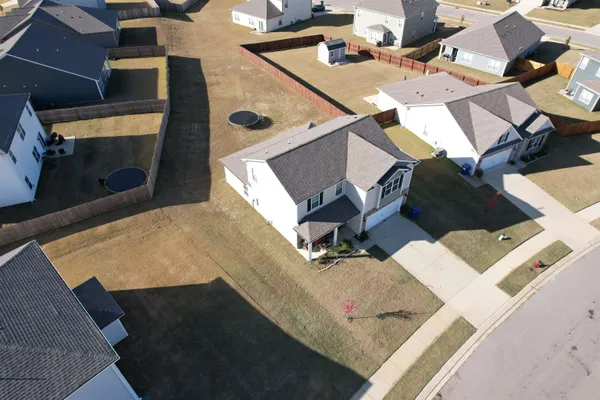 an aerial view of a house with a yard