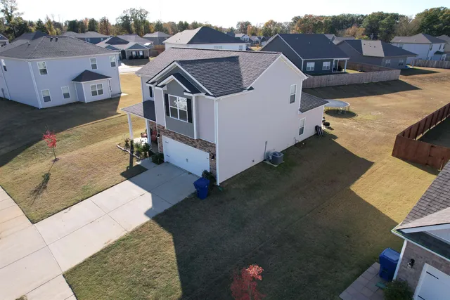 an aerial view of a house with a yard