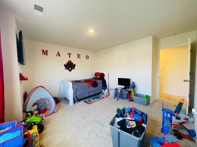 a bedroom with furniture and a baby crib