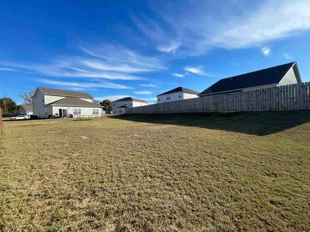 a view of residential houses with yard
