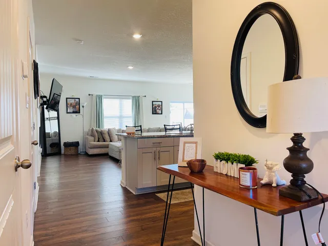 a dining room with furniture and a floor to ceiling window