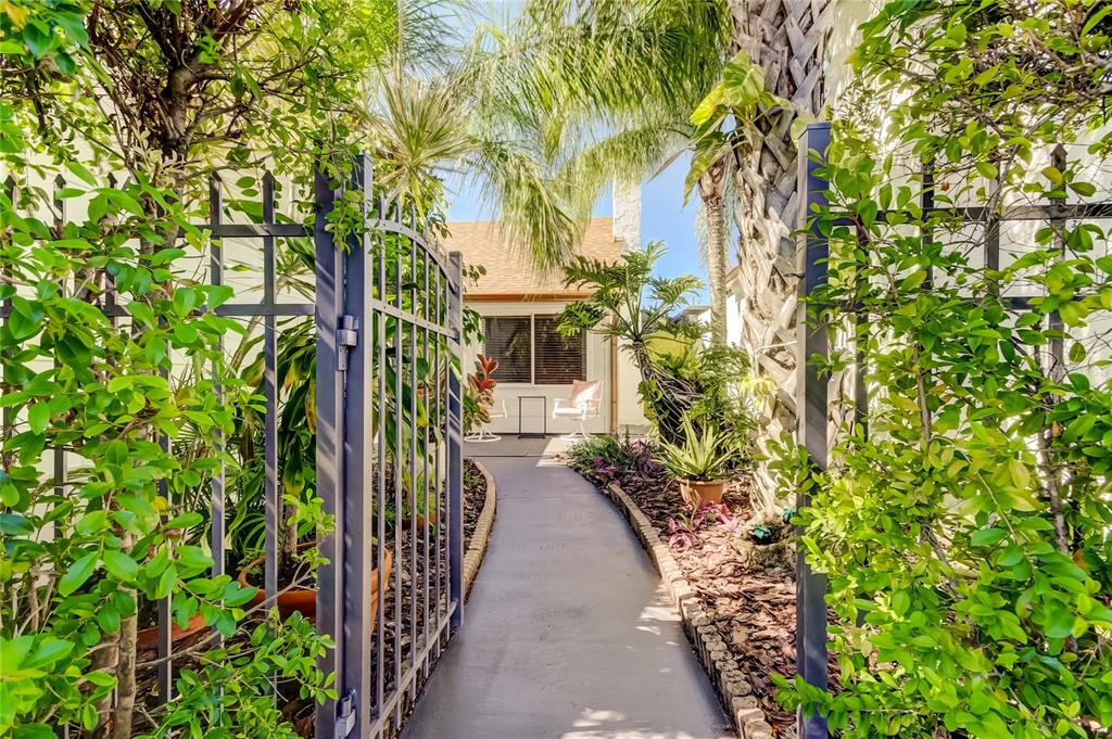 12625 Shell Point Drive Hudson, FL 34667 - Photo 1 of 61 a view of a pathway of a house with flower plants