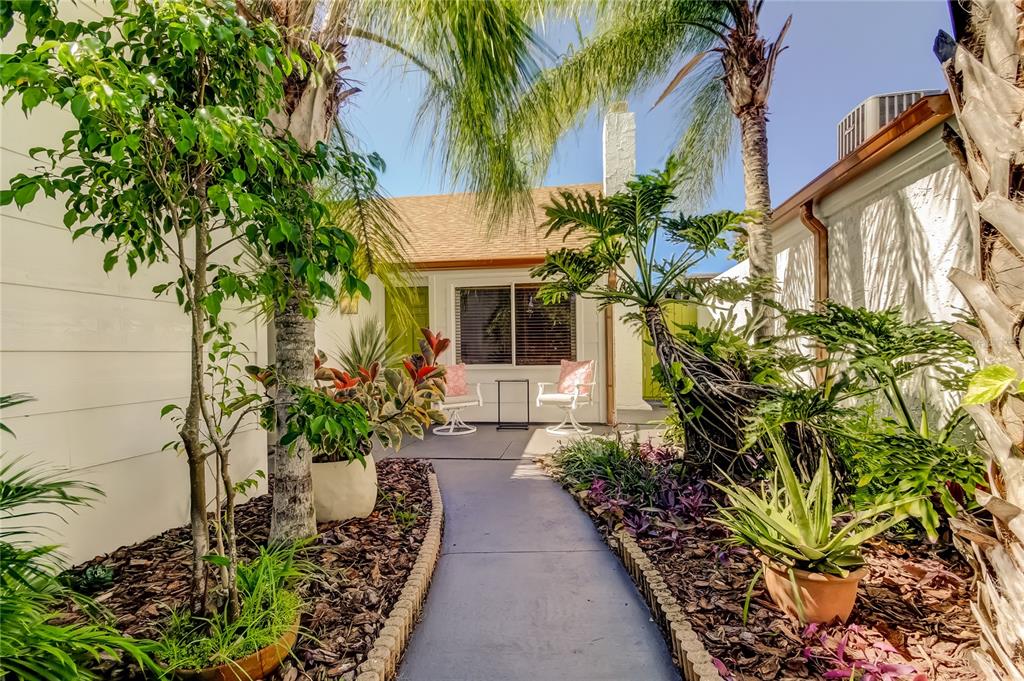 12625 Shell Point Drive Hudson, FL 34667 - Photo 3 of 61 a house with flower garden in front of it
