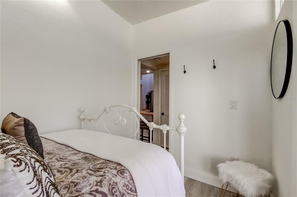 12625 Shell Point Drive Hudson, FL 34667 - Photo 35 of 61 a bedroom with a bed and a mirror